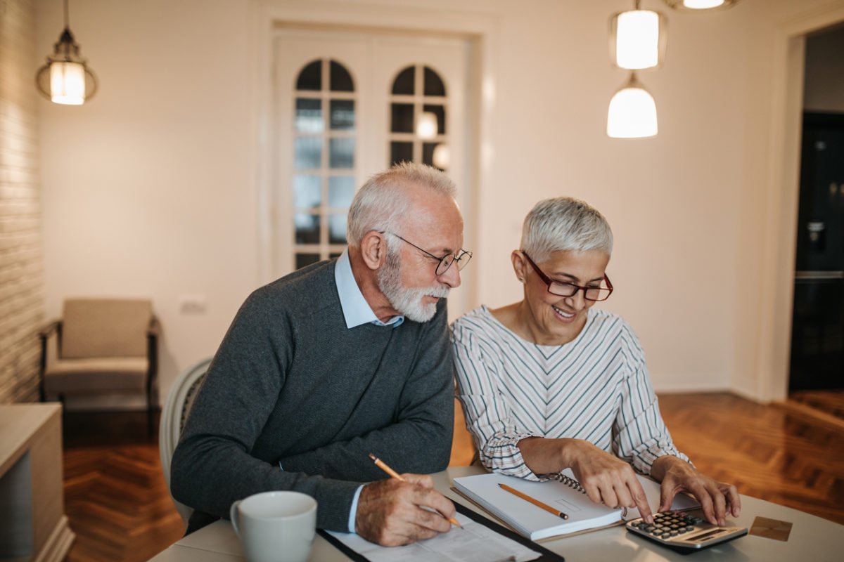A happy senior couple deciding if they are ready to downsize their home.