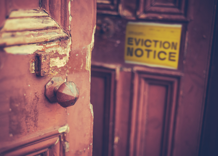 An eviction notice on a door to evict a tenant quickly.
