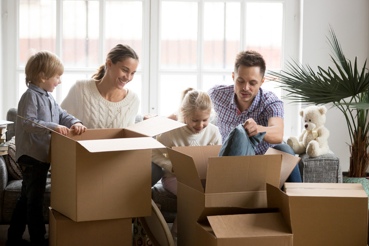 A family packing boxes and selling their house to cash buyers.